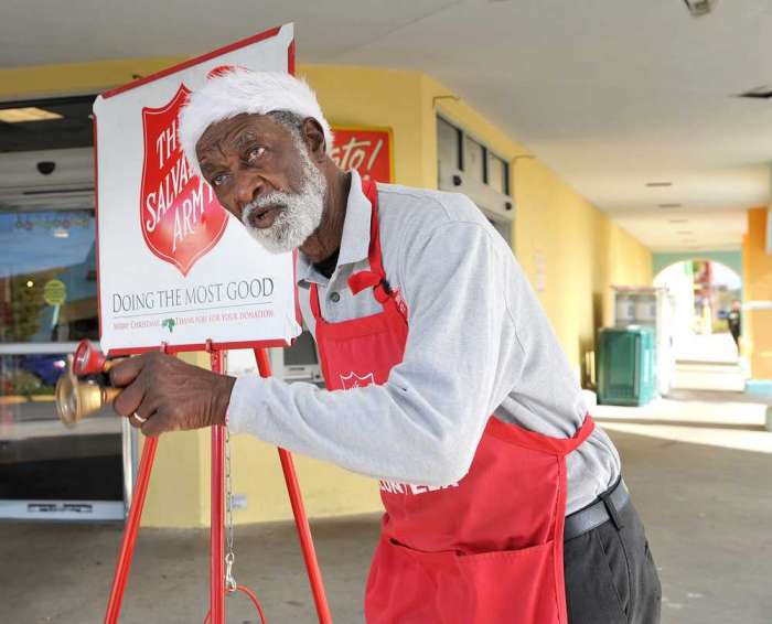 Harold Pierce sings'Oh What A Beautiful Morning to customers arriving at Publix. Pierce 77 rang two bells and sang next to his Salvation Army red kettle at Gateway Shopping Center on Wednesday. It is his ninth year as a bell ringer