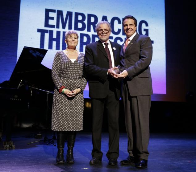Gov. Cuomo receives an award during an event on World AIDS Day at the Apollo Theater in Harlem. New York will dedicate $200 million more to its $2.5 billion effort to end the AIDS epidemic by 2020
