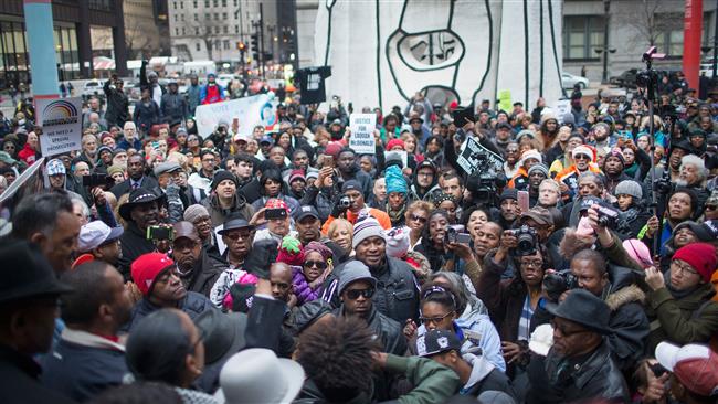 Demonstrators rally at the Thompson Center following a march through downtown to protest the death of Laquan Mc Donald and the alleged cover-up that followed in Chicago Illinois