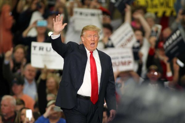 Republican presidential candidate Donald Trump waves during