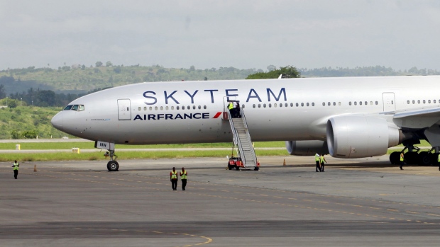 Airport workers are seen near the Air France Boeing 777 aircraft that made an emergency landing