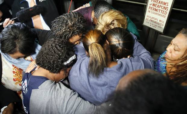 Supporters of the victims of former Oklahoma City police officer Daniel Holtzclaw pray after the verdicts were read for the charges against him at the Oklahoma County Courthouse in Oklahoma City Thursday Dec. 10 2015. Holtzclaw was found guilty of 18