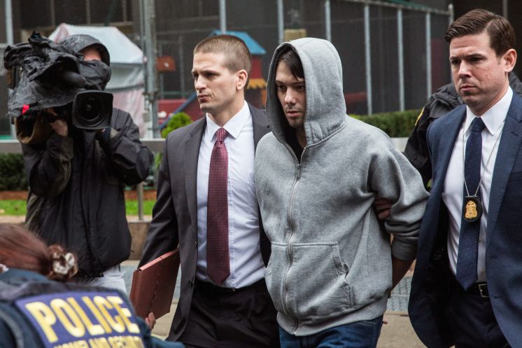 Martin Shkreli center CEO of Turing Pharmaceutical is escorted after being arrested Thursday in New York City. Shkreli who was charged with securities fraud gained notoriety earlier this year for raising the price of Daraprim though the arrest isn