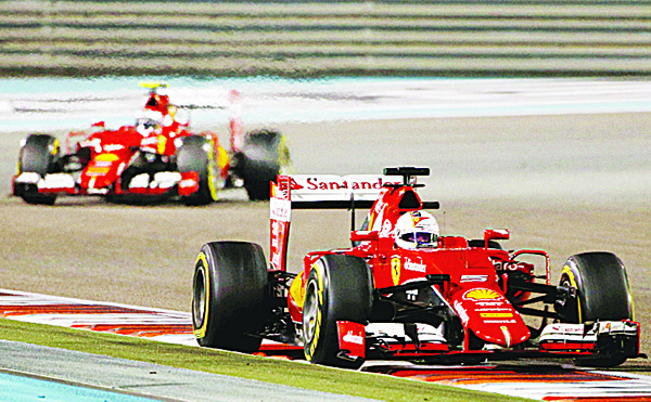 Ferrari’s German driver Sebastian Vettel, and Ferrari’s Finnish driver Kimi Raikkonen race during the Abu Dhabi Formula One Grand Prix at the Yas Marina circuit on Nov 29