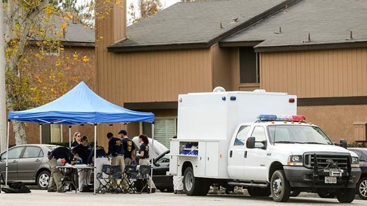 FBI agents outside a home in Redlands California linked to the shootings