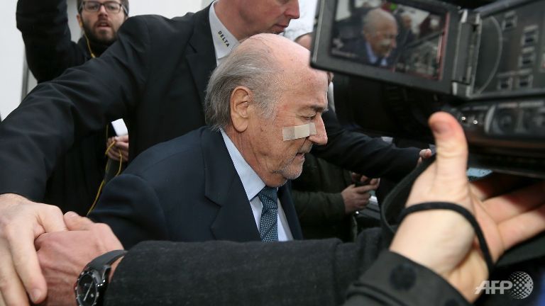 Suspended FIFA president Sepp Blatter leaves after a press conference