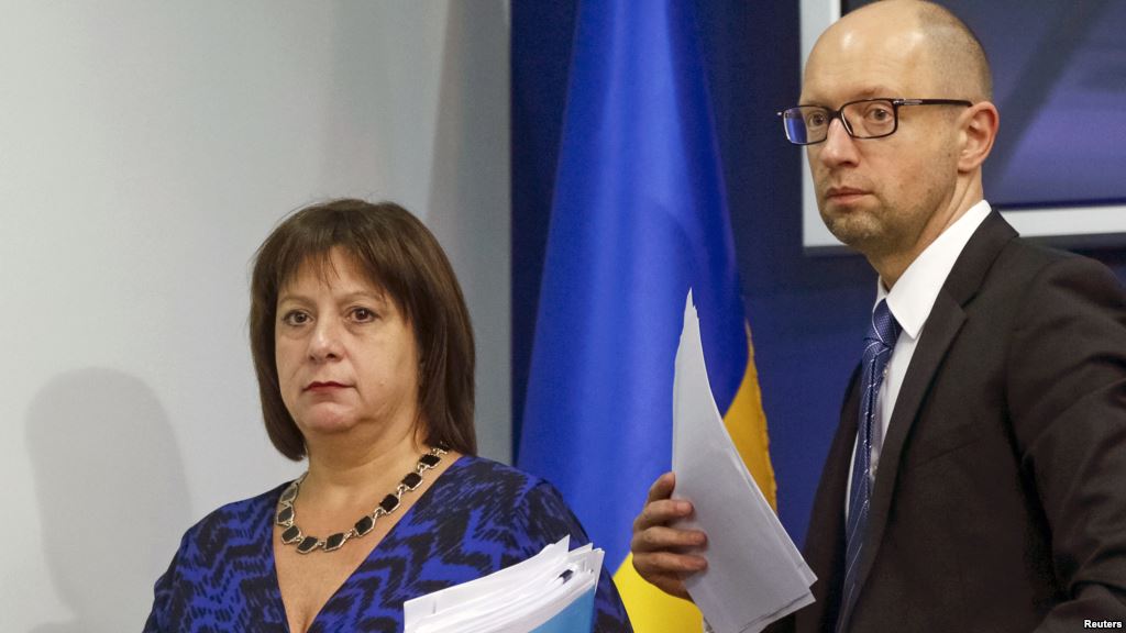 FILE- Ukraine's Prime Minister Arseny Yatseniuk and Finance Minister Natalia Yaresko leave a news conference in Kyiv Ukraine Oct. 15 2015