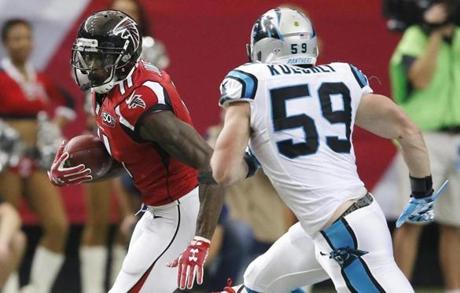 Atlanta Falcons wide receiver Julio Jones runs after a catch against Carolina Panthers middle linebacker Luke Kuechly during the first half of an NFL football game Sunday Dec. 27 2015 in Atlanta. Kuechly was called for a penalty for a horse