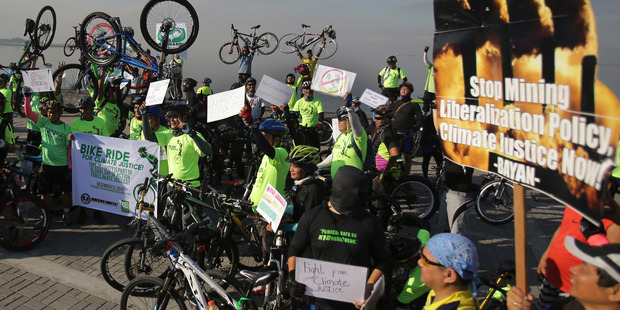 Filipinos raise their bicycles as they join a rally in Manila Philippines