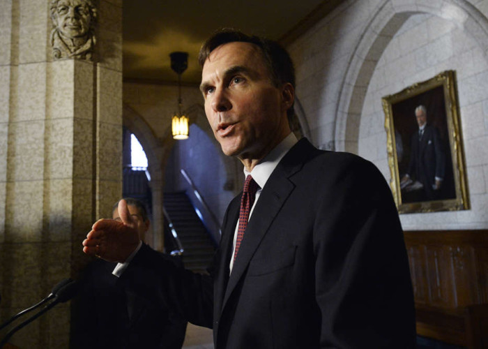 Finance Minister Bill Morneau talks with media outside the House of Commons on Friday Dec. 11 2015. iPolitics  Matthew Usherwood