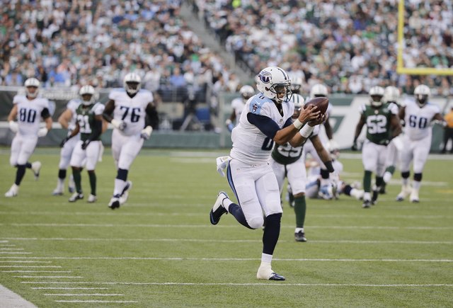 ASSOCIATED PRESS           Tennessee Titans quarterback Marcus Mariota catches a pass during the second half of an NFL football game against the New York Jets Sunday in East Rutherford N.J. Mariota scored a touchdown on the pla