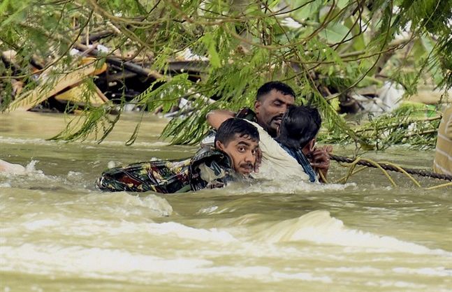 Indian army soldiers rescue a man from flood waters in Chennai India Thursday Dec. 3 2015. The heaviest rainfall in more than 100 years has devastated swathes of the southern Indian state of Tamil Nadu with thousands forced to leave their submerged