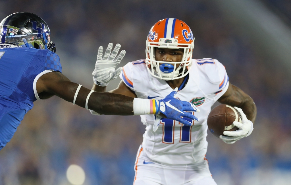 Demarcus Robinson #11 of the Florida Gators runs with the ball while defended by J.D. Harmon #11 of the Kentucky Wildcats at Commonwealth Stadium