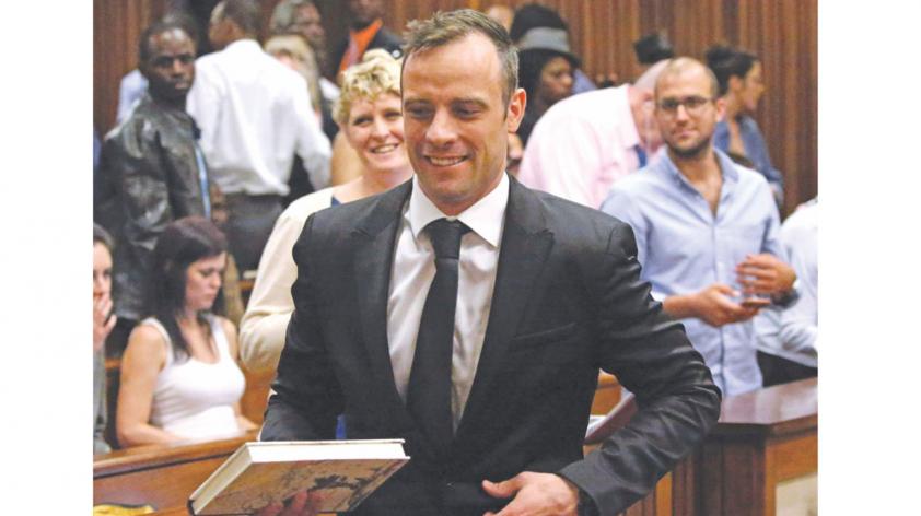 Former Paralympic champion Oscar Pistorius smiles as he leaves the North Gauteng High Court in Pretoria after securing bail yesterday