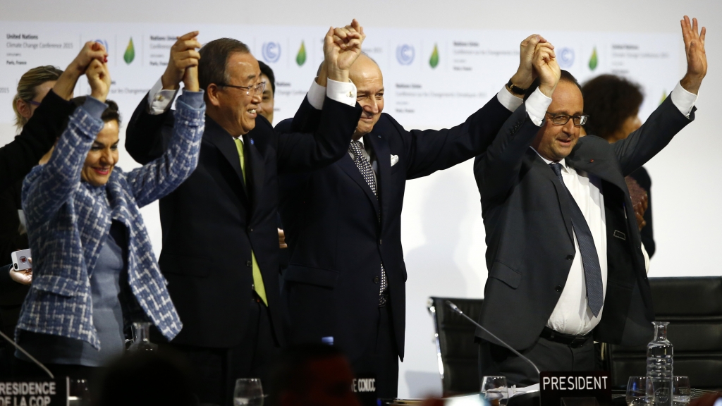 French President Francois Hollande right French Foreign Minister and president of the COP21 meetings Laurent Fabius second right UN climate chief Christiana Figueres left and UN Secretary General Ban ki Moon join hands after the final adoption of