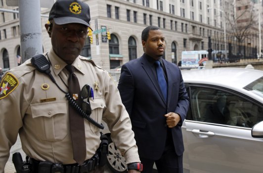 Officer William Porter right one of six Baltimore city police officers charged in connection to the death of Freddie Gray walks into a courthouse during jury deliberations Wednesday Dec. 16 2015 in Baltimore. Jurors are in their third day of delibe