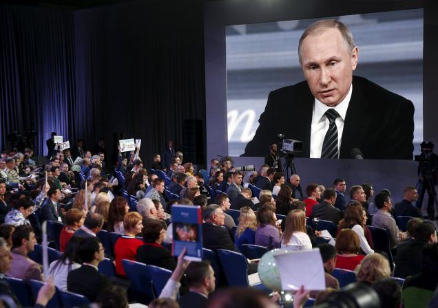 Journalists listen to Russian President Vladimir Putin during his annual end-of-year news conference in Moscow