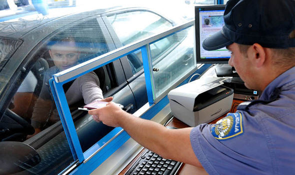 Border official checking passport