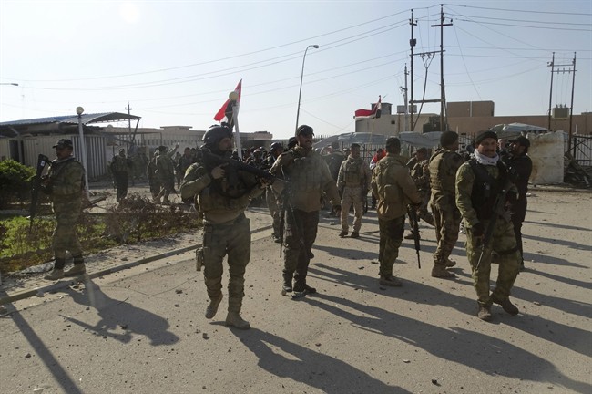 Iraqi security forces enter the government complex in central Ramadi 70 miles west of Baghdad Iraq Monday Dec. 28 2015. Iraqi military forces on Monday retook a strategic government complex in the city of Ramadi from Islamic State