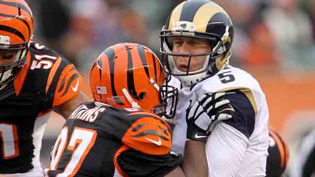 Geno Atkins #97 of the Cincinnati Bengals hits Nick Foles #5 of the St. Louis Rams at Paul Brown Stadium