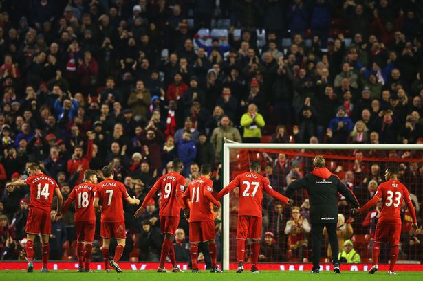 Jurgen Klopp manager of Liverpool and player salute The Kop after the Barclays Premier League match between Liverpool and West Bromwich Albion at Anfield