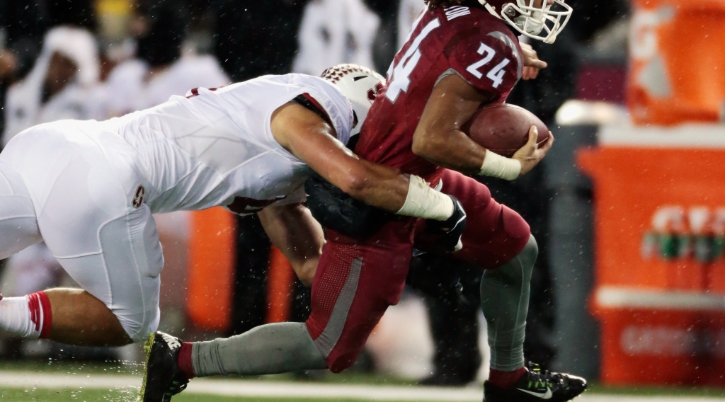 PULLMAN WA OCTOBER 31 Keith Harrington #24 of the Washington State Cougars carries the ball against Blake Martinez #4 of the Stanford Cardinal in the game at Martin Stadium