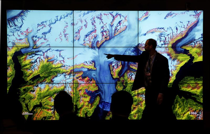 People attend a climate conference at the U.S. pavilion during the COP21 United Nations Climate Change Conference in Le Bourget north of Paris today