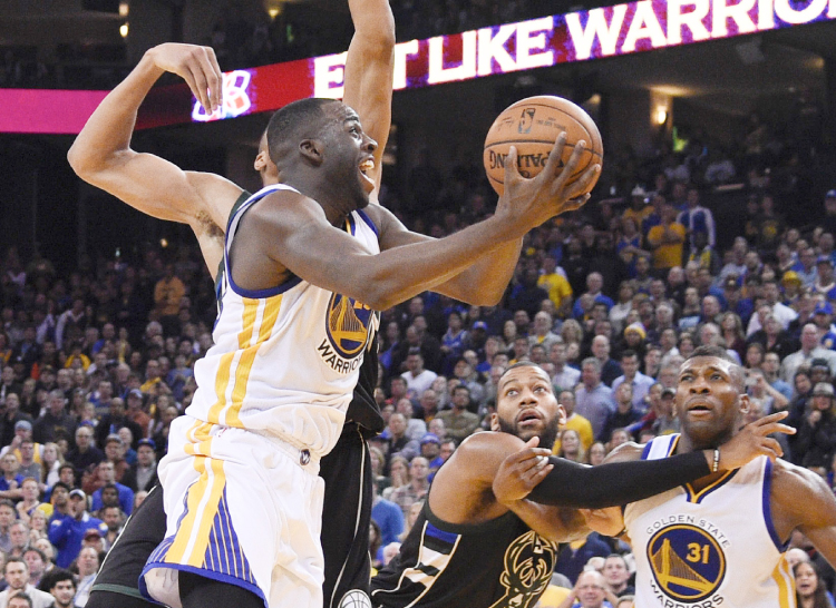 Golden State Warriors’ Draymond Green shoots during their NBA game against the Milwaukee Bucks in Oakland Friday. — Reuters