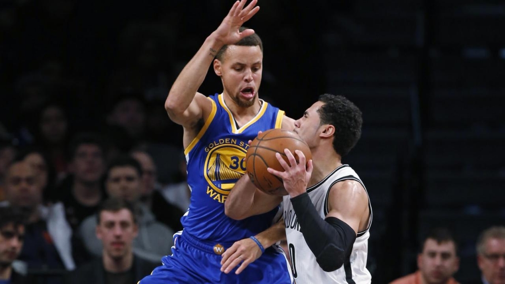 Warriors Stephen Curry defends Nets Shane Larkin in the first half of an NBA basketball game Sunday Dec. 6 2015 in New York