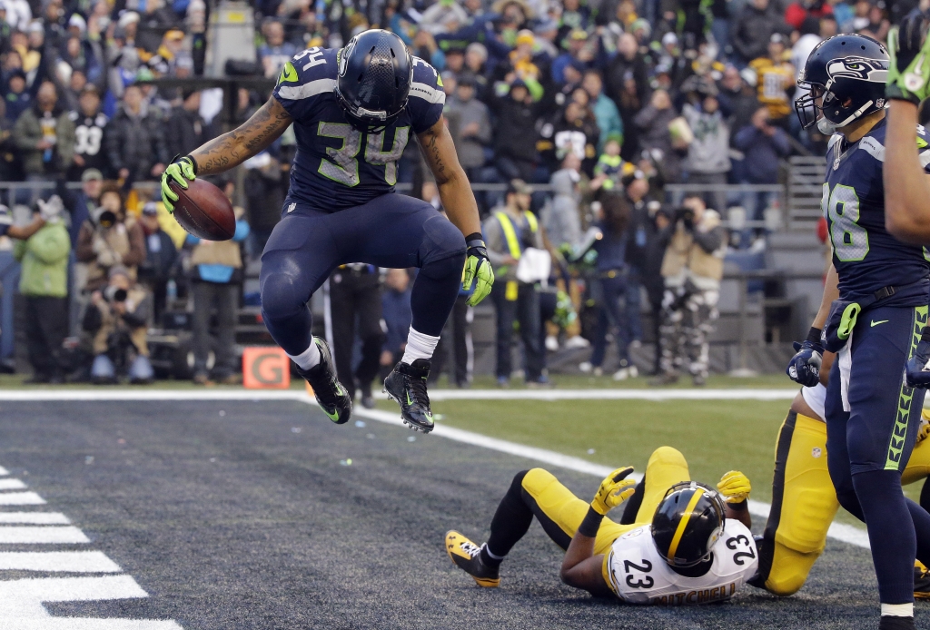 Seattle Seahawks&#039 Thomas Rawls jumps after scoring a touchdown as Pittsburgh Steelers&#039 Mike Mitchell lies in the end zone in the second half of an NFL football game Sunday Nov. 29 2015 in Seattle. ORG XMIT SEA1