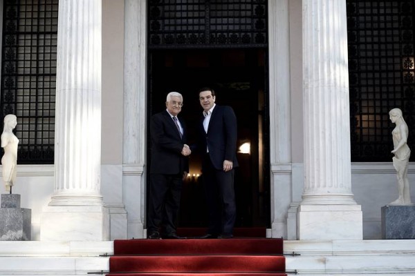 Greek Prime Minister Alexis Tsipras right shakes hands with Palestinian president Mahmud Abbas before their meeting in Athens on Monday
