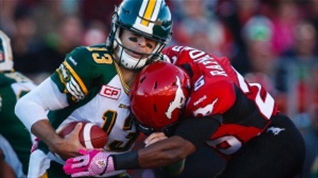 Edmonton Eskimos quarterback Mike Reilly left is sacked by Calgary Stampeders Keon Raymond during a game on Saturday Oct. 10 2015. Reilly has put up some pretty impressive numbers since returning to action for his Eskimos. A minor detail that many