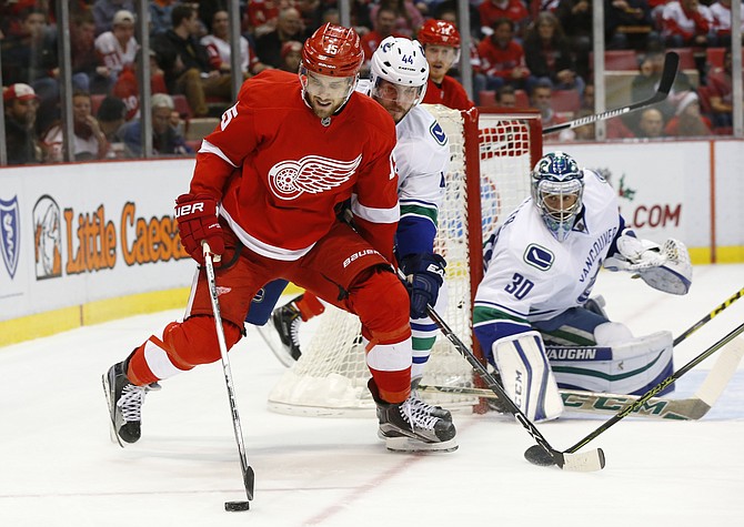 Detroit Red Wings center Riley Sheahan skates with the puck against the Vancouver Canucks in the first period Friday Dec. 18 2015 in Detroit