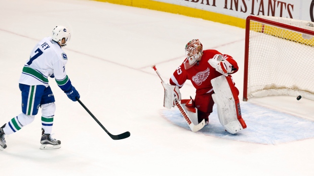 Linden Vey slips a shot past Jimmy Howard in the Red Wings goal as the Vancouver Canucks won a shootout and a 4-3 triumph in Detroit Friday night