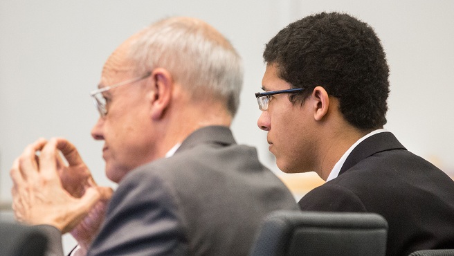 Defense attorney John Osler left sits beside Phillip Chism during his trial at Essex Superior Court in Salem Mass. Monday Dec. 7 2015