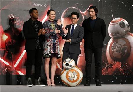 Director J.J. Abrams second right and actors from left John Boyega Daisy Ridley and Adam Driver right pose for a group