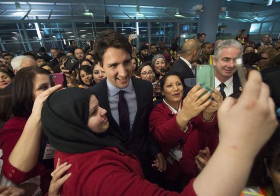 Canadian Prime Minister Justin Trudeau centre poses for