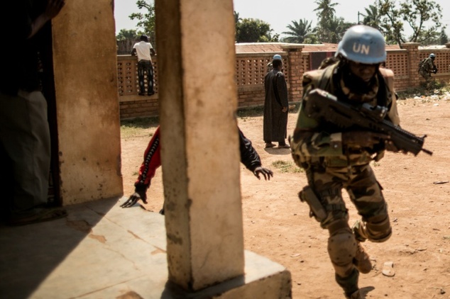 A Senegalese soldier from the MINUSCA the United Nations mission in Central African Republic runs for cover as heavy gunfire is directed towards where vote