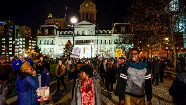 Protesters march at city hall in Baltimore after a mistrial was declared in the case of Baltimore police Officer William Porter charged in the death of Freddie Gray