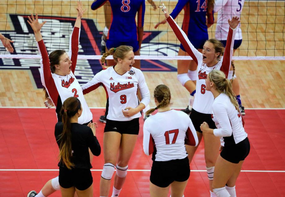 Nebraska players celebrate a point against Kansas during an NCAA women's volleyball tournament semifinal in Omaha Neb. Thursday Dec. 17 2015