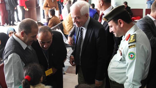 Immigration minister John McCallum second from right talks to a Syrian family leaving Jordan to live in Canada