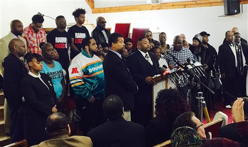 The Rev. Marvin Hunter center the great uncle of Laquan McDonald accompanied by other family members and supporters speaks at a Dec. 11 news conference in Chicago. AP