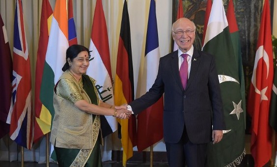 Pakistan's National Security Adviser Sartaj Aziz  shakes hands with Indian Foreign Minister Sushma Swaraj at Pakistan's foreign ministry in Islamabad