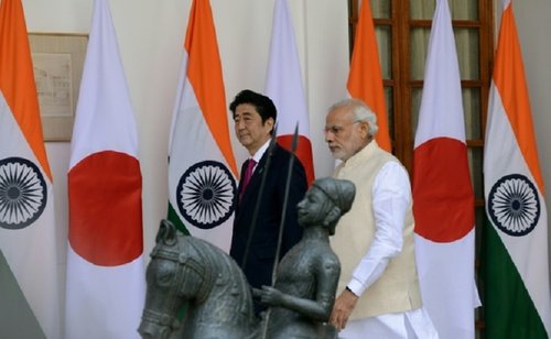 India's Prime Minister Narendra Modi walks with Japan's Prime Minister Shinzo Abe at Hyderabad House in New Delhi