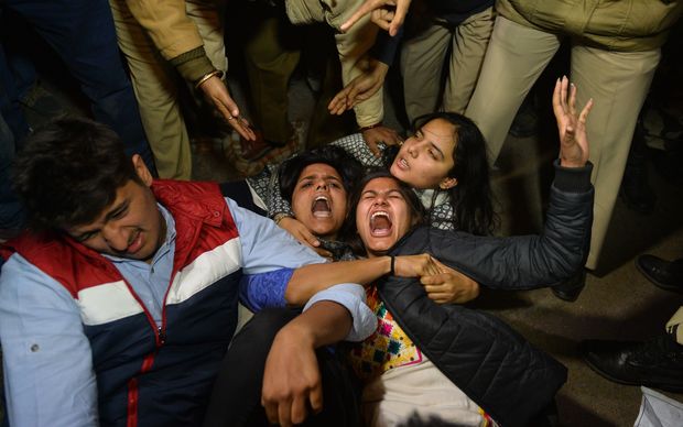 Indian demonstrators shout slogans as they resist arrest at a rally to protest the release of a juvenile rapist