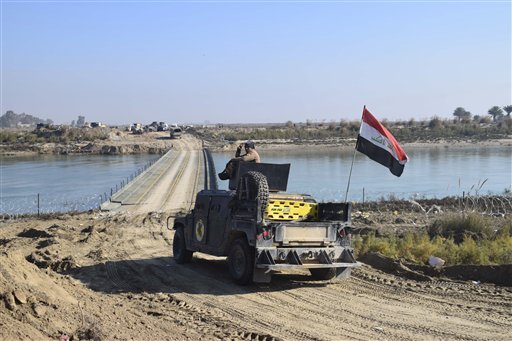 Iraqi security forces cross a bridge built by corps of Engineers over the Euphrates River as Islamic State destroyed all the bridges leading to central Ramadi to block Iraqi security forces from moving forward in Ramadi 70 miles west