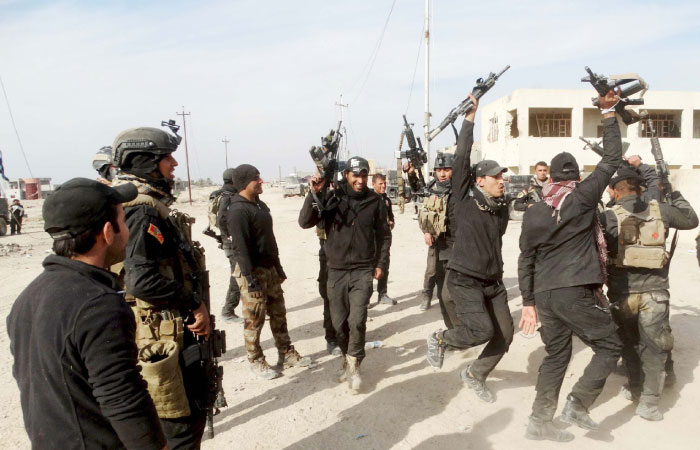 Iraqi security forces chant slogans in the city of Ramadi. — Reuters