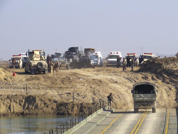 Iraqi security forces cross a bridge built by corps of engineers over the Euphrates in Ramadi