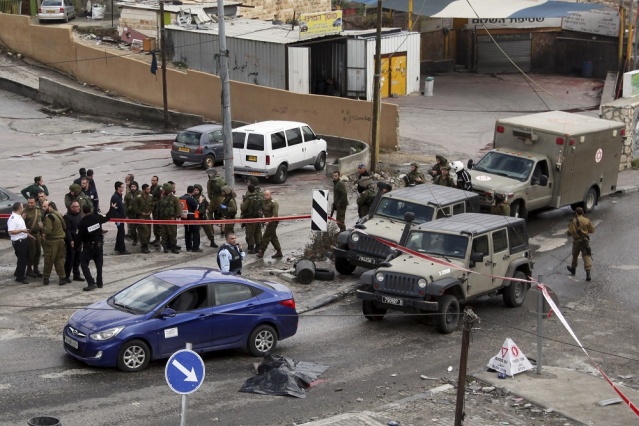 A body of a Palestinian identified as Mazen Hassan Aribah lies covered with a plastic sheath near the village of Hizmeh West Bank Thursday