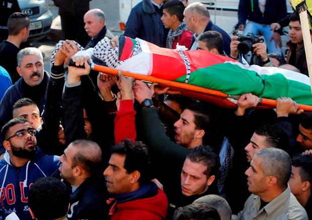 Mourners carry the body of Palestinian Maher Aljabi 56 whom medics said was shot and killed by Israeli troops on Saturday during his funeral in the West Bank city of Nablus